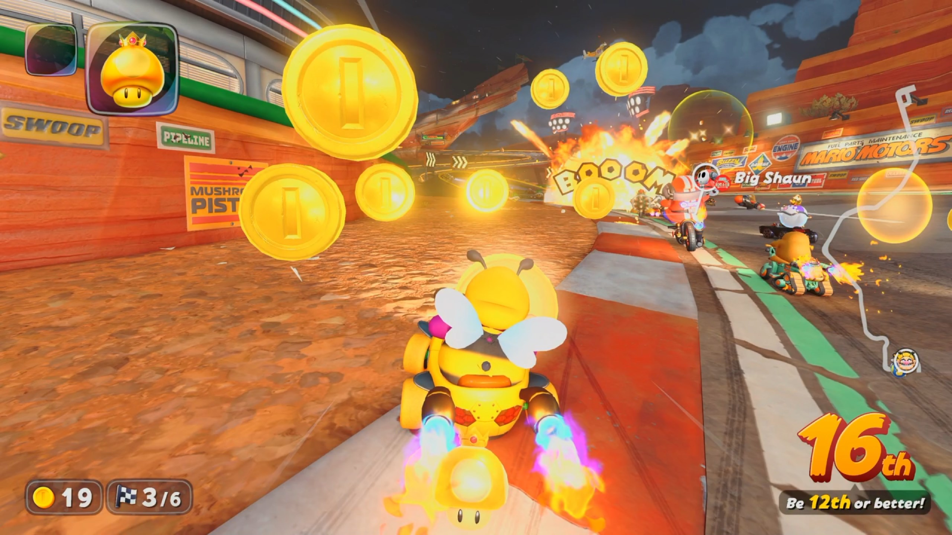 Wario driving in a wasp costume in a bee themed car in Mario Kart World as coins dot across the screen and an explosion occurs in the distance.