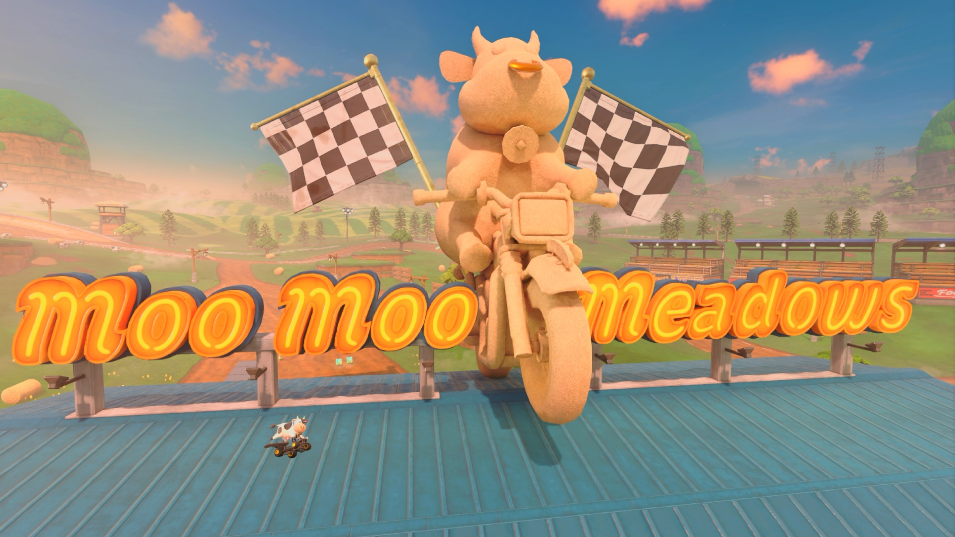 A cow flying a car past a large statue of a cow driving a motorcycle and a sign that says "Moo Moo Meadows" in Mario Kart World.
