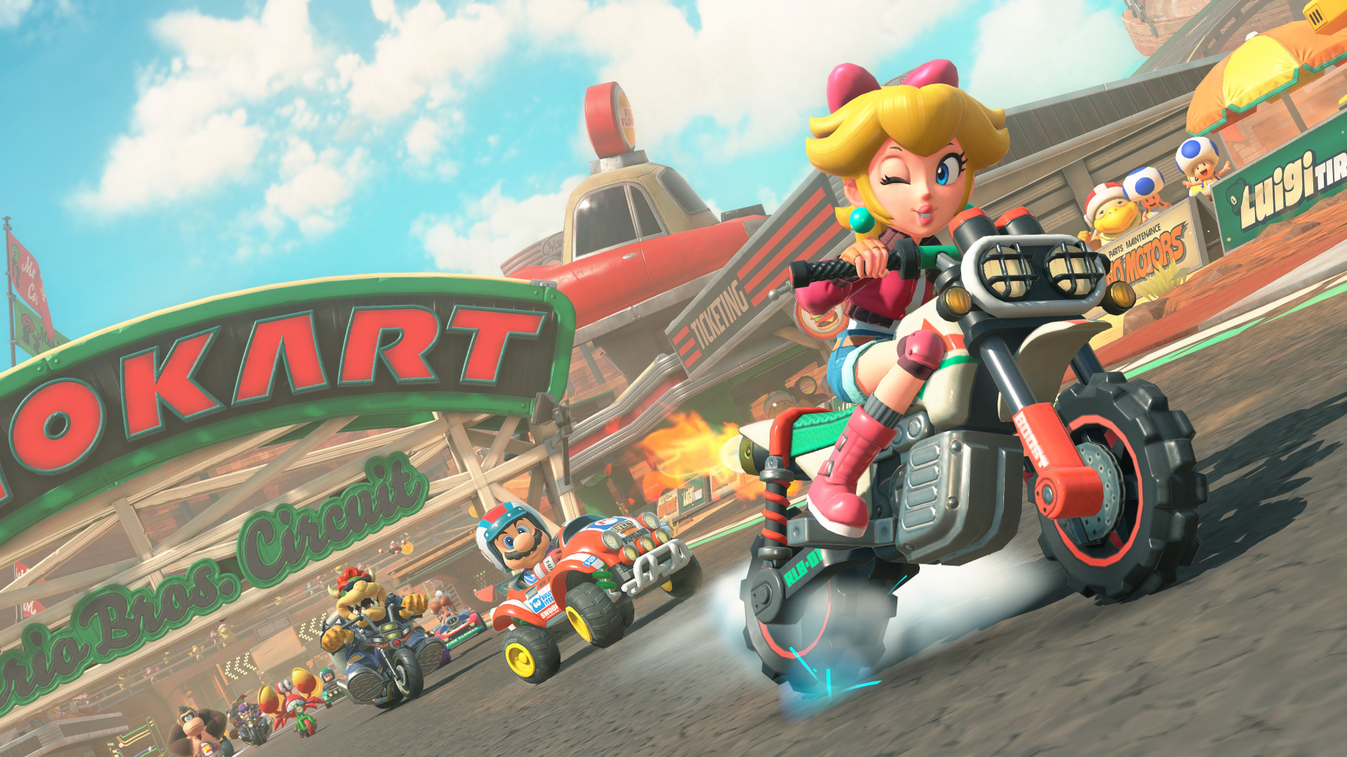 Peach riding a motorbike and winking as she leads the race in Mario Kart World.